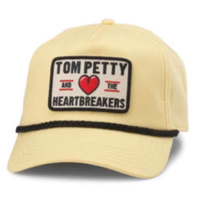 Beige trucker hat featuring Tom Petty and the Heartbreakers logo patch with red heart and black braided band.
