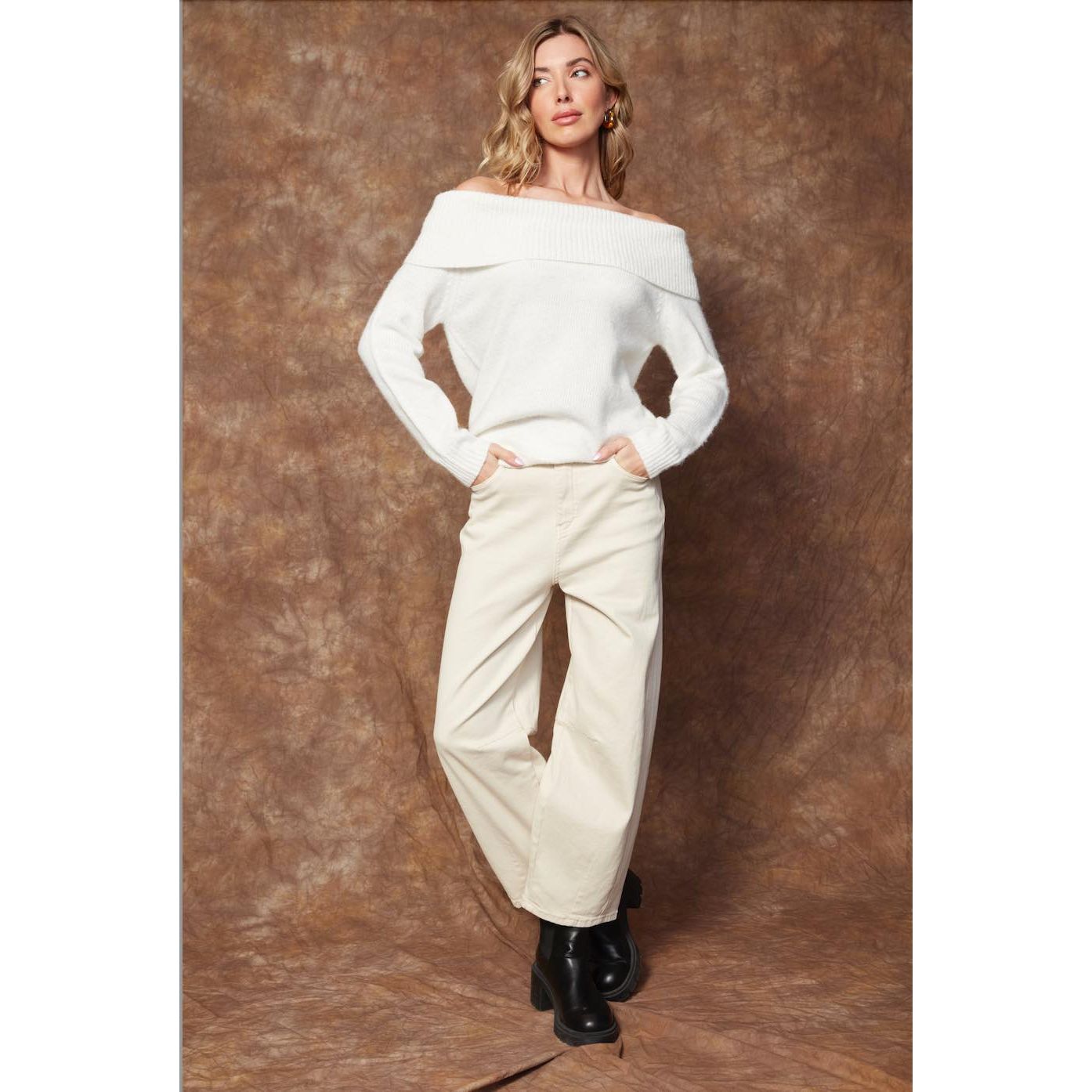 Angelique Raglan Long Sleeve Sweater on a model in white knit with off-shoulder neckline and relaxed fit.