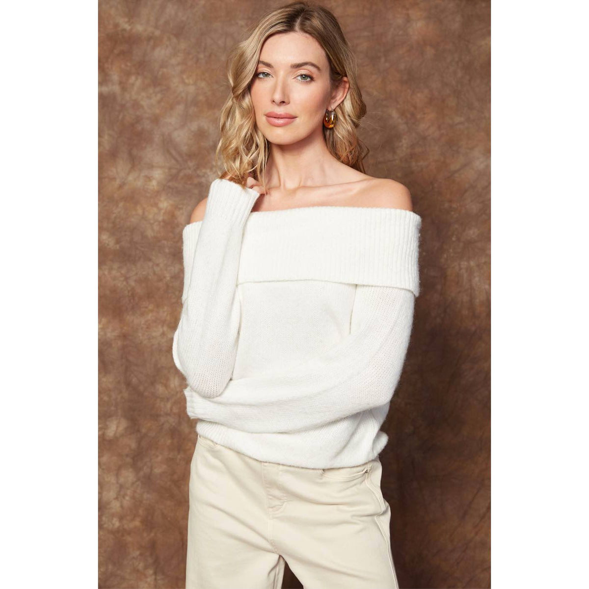 Model wearing Angelique Raglan Long Sleeve Sweater in white knit, off-shoulder neckline, relaxed fit.