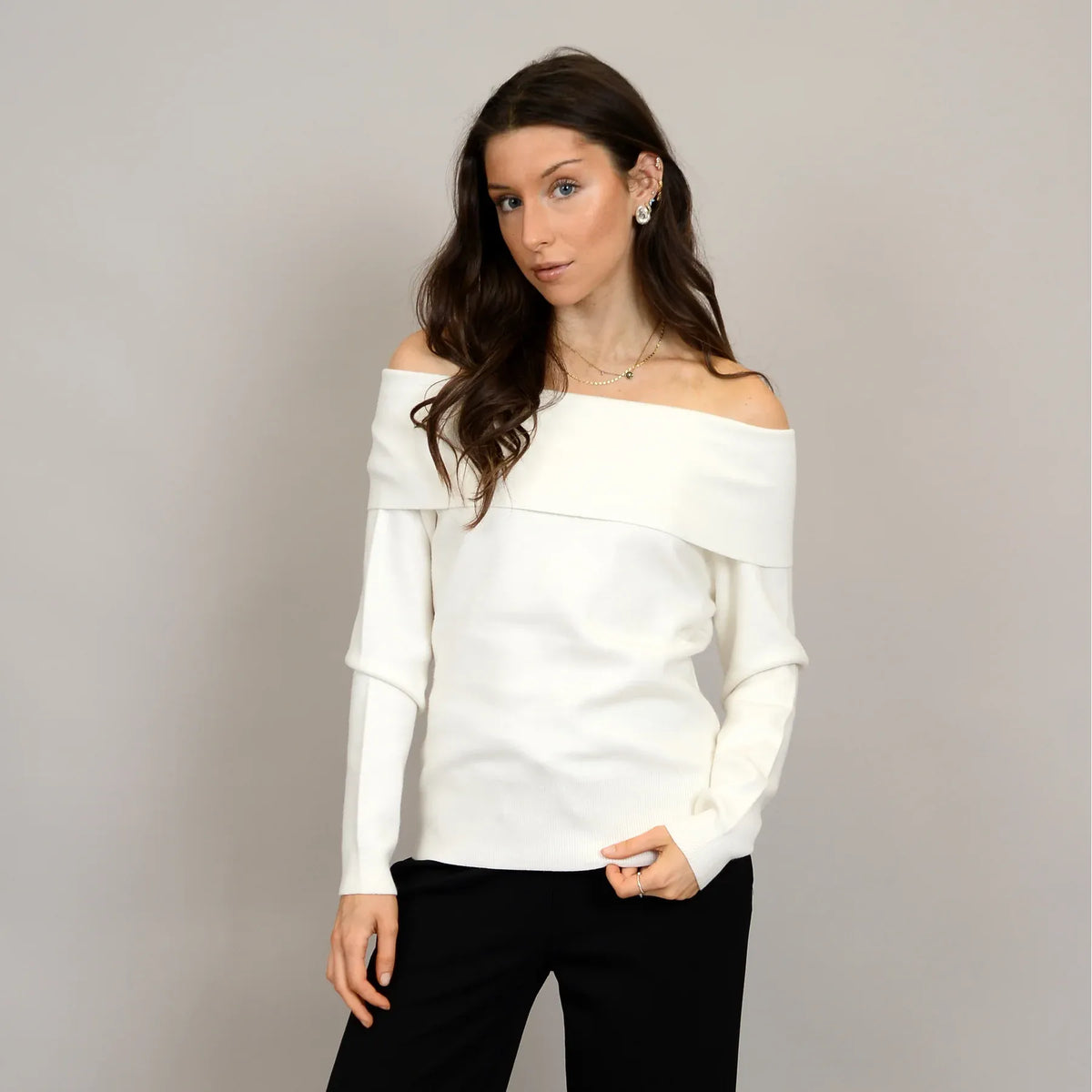 Angelique Raglan Long Sleeve Sweater on a model in ivory knit with off-shoulder neckline and extended sleeves.