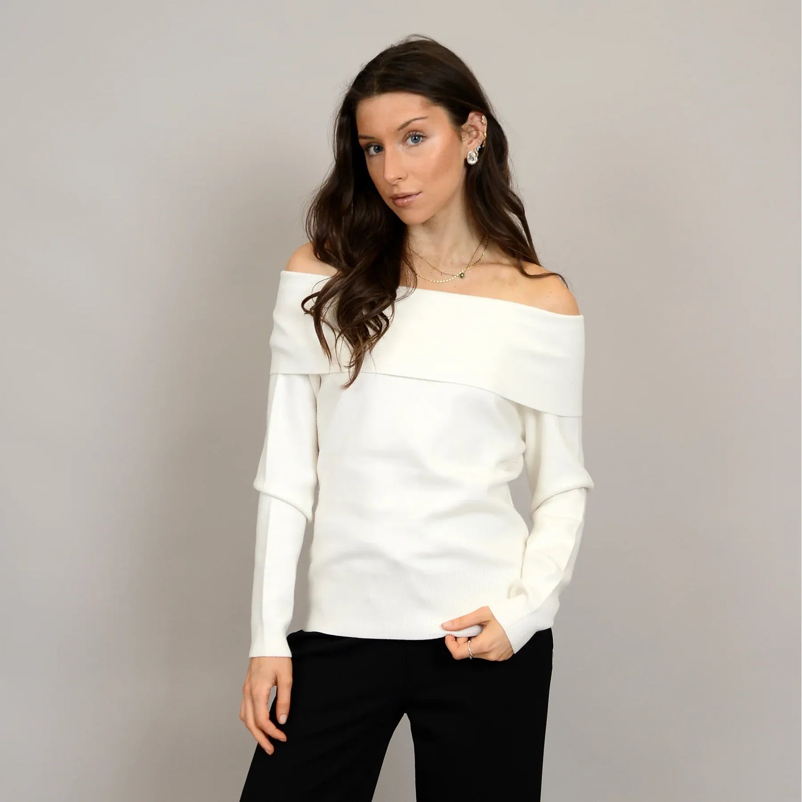 Angelique Raglan Long Sleeve Sweater on a model in ivory knit with off-shoulder neckline and extended sleeves.