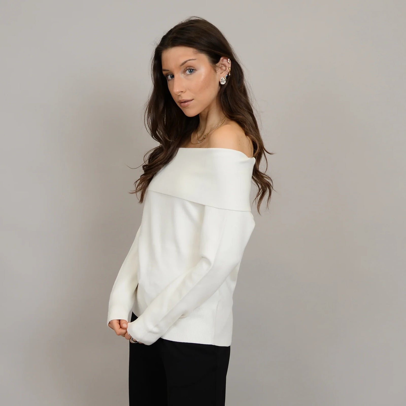 Angelique Raglan Long Sleeve Sweater on a model in ivory knit with off-shoulder neckline and extended sleeves.