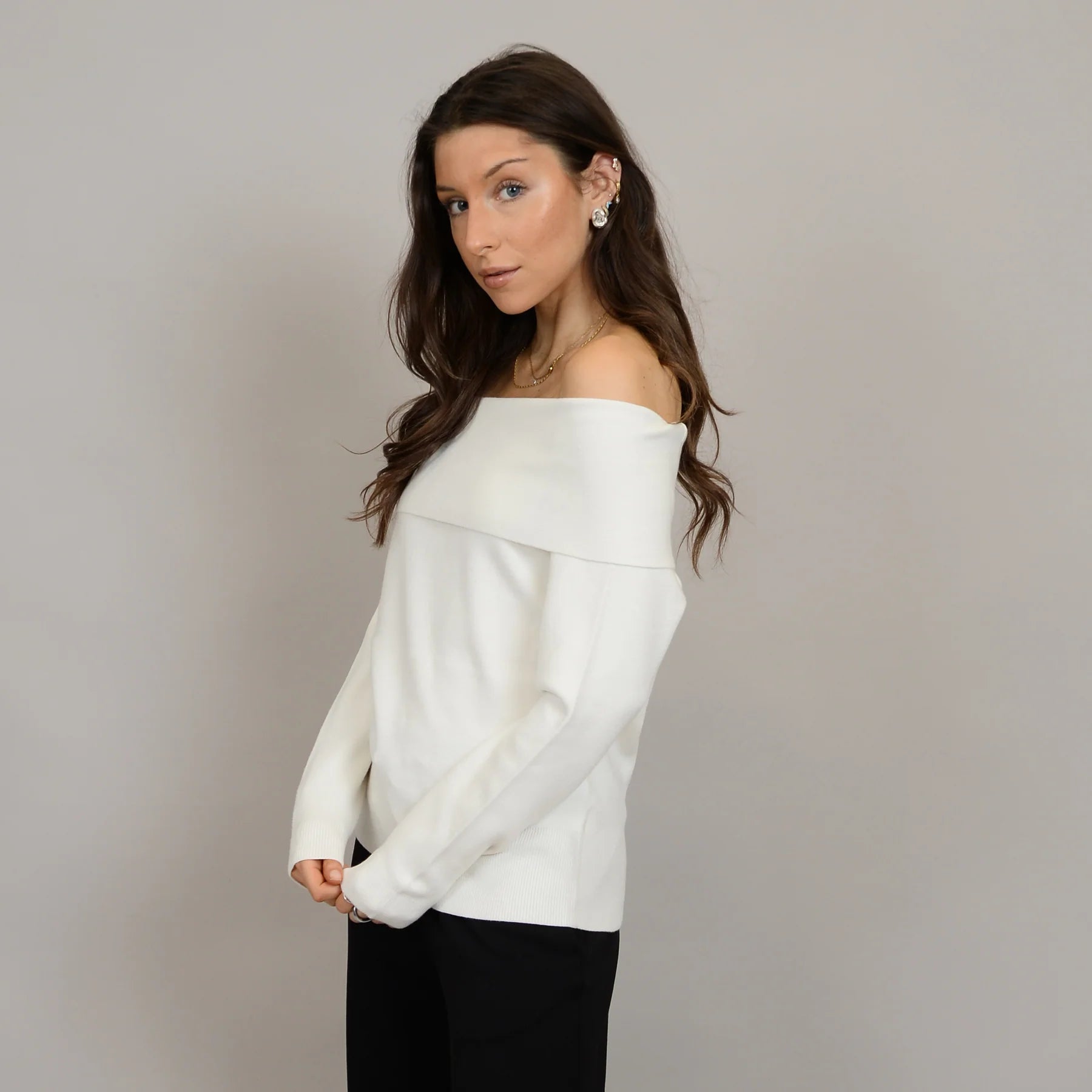 Angelique Raglan Long Sleeve Sweater on a model in ivory knit with off-shoulder neckline and extended sleeves.