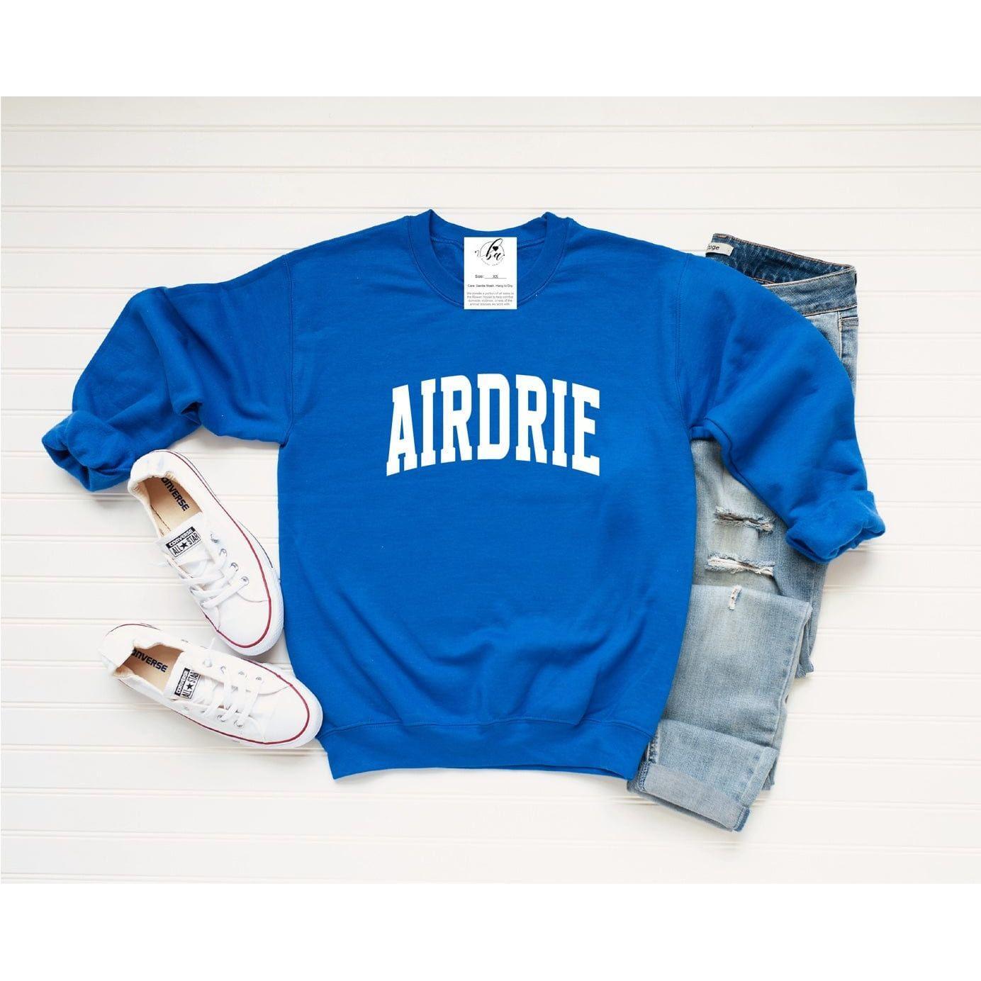 Royal blue Airdrie Cozy Crew sweatshirt, perfect for chilly nights and showcasing hometown pride.
