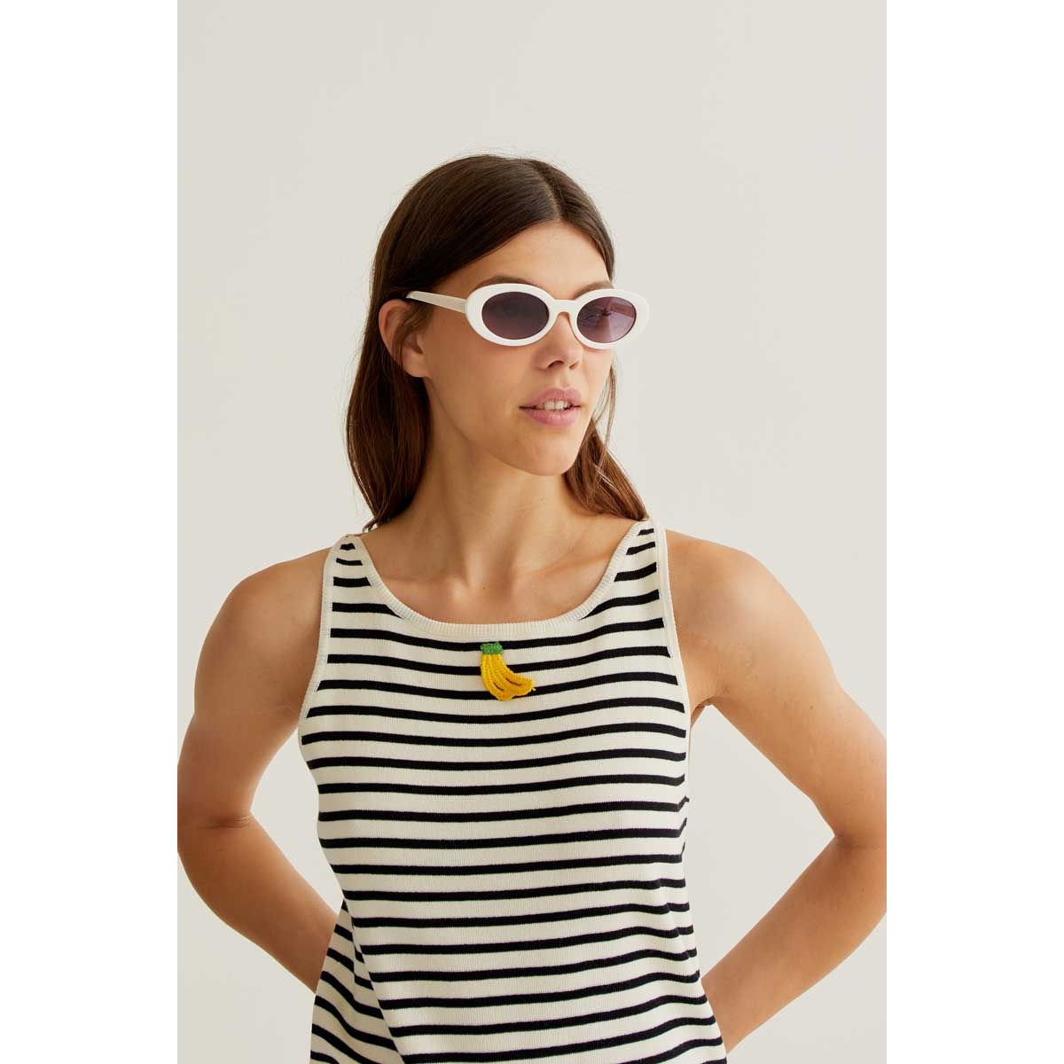 Model wearing Banana on Black Stripes Tank with a banana applique on cream and black striped viscose top