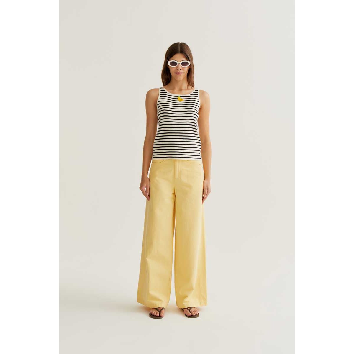 Banana on Black Stripes Tank worn by model; striped knit top with banana graphic.