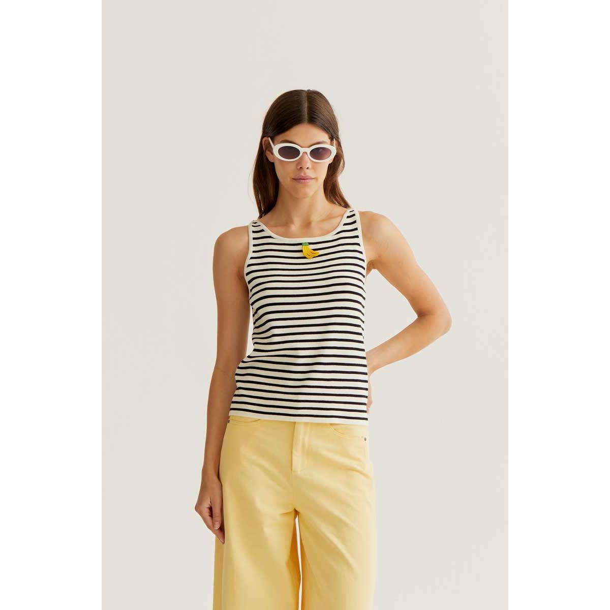 Banana on Black Stripes Tank: model wearing white tank with black stripes and small yellow banana graphic.