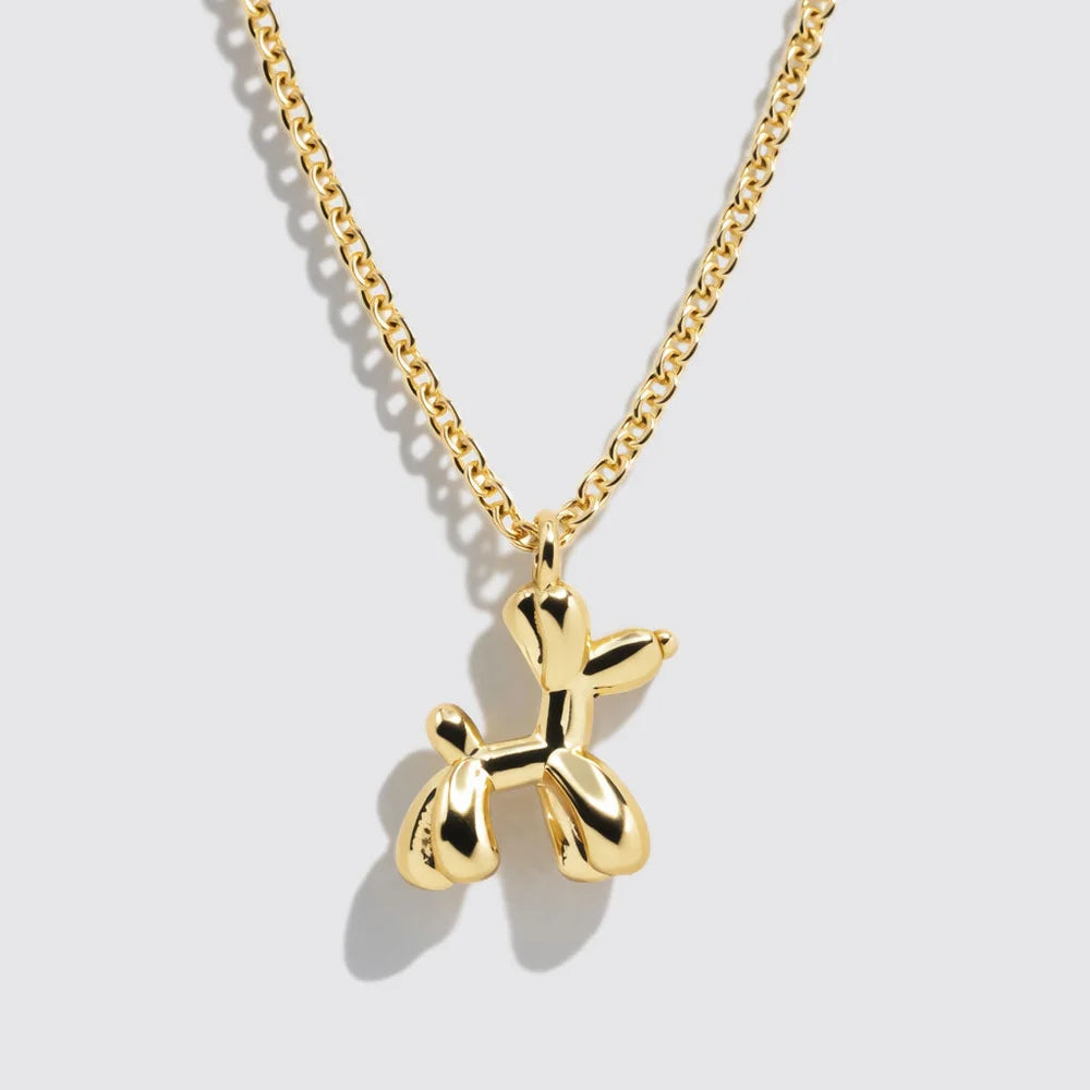 Gold chain necklace featuring a sculpted balloon dog pendant. A playful and modern accessory that adds a nostalgic twist to everyday style.