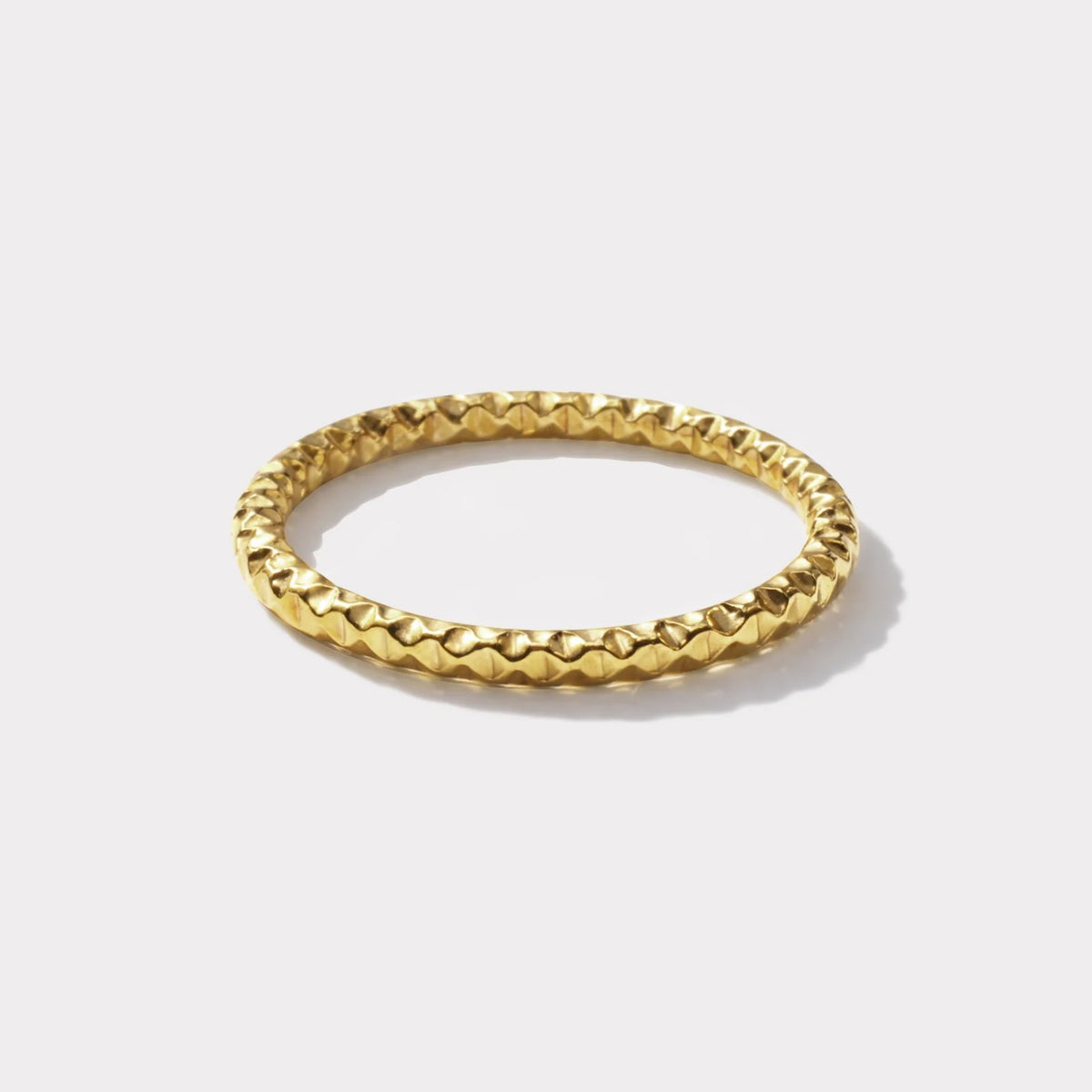 Gold-tone hammered ring with geometric texture for a modern edge; hypoallergenic and water-resistant.