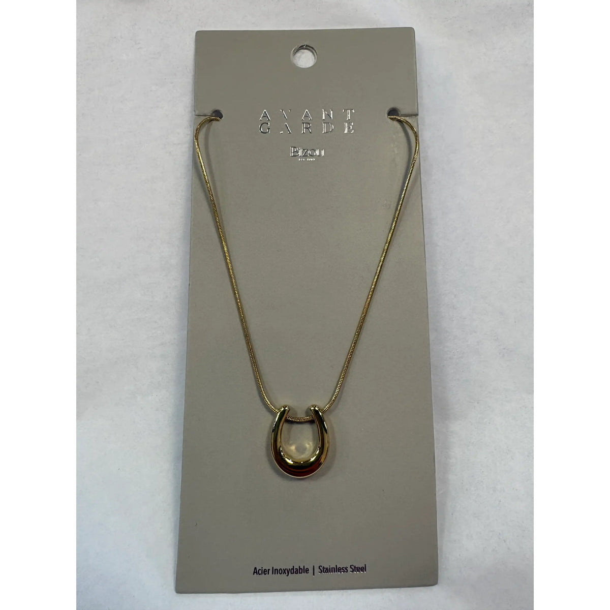 Gold-tone stainless steel Bizou horseshoe charm necklace on a fine chain. Dainty good luck pendant, hypoallergenic and water-resistant.