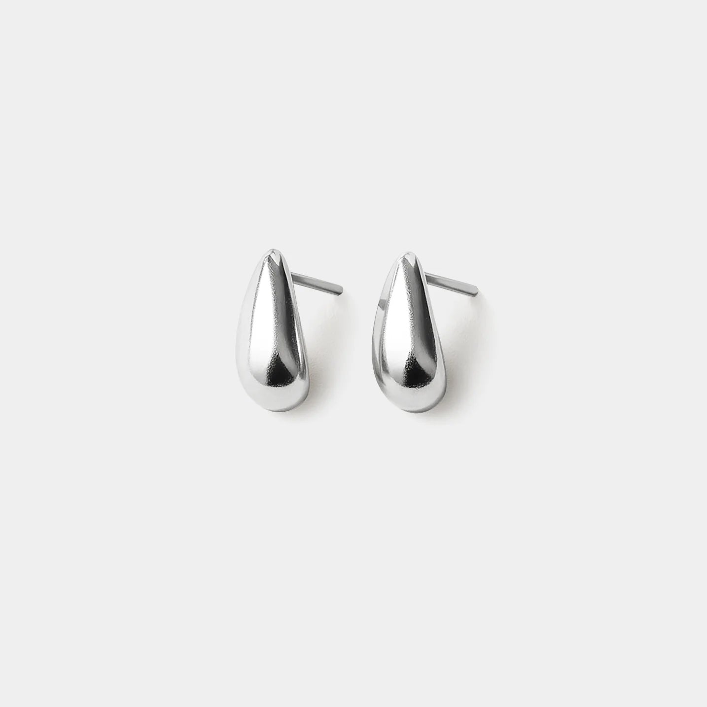 Minimalist silver drop earrings in teardrop shape (0.5 × 1 cm); stainless steel with post backs.