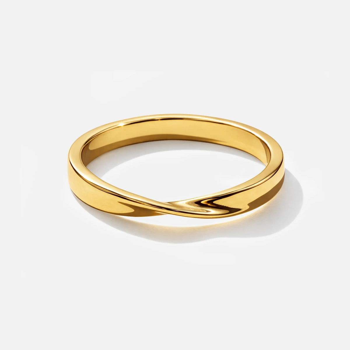 Twisted metal ring in gold-tone finish with a smooth, polished band.