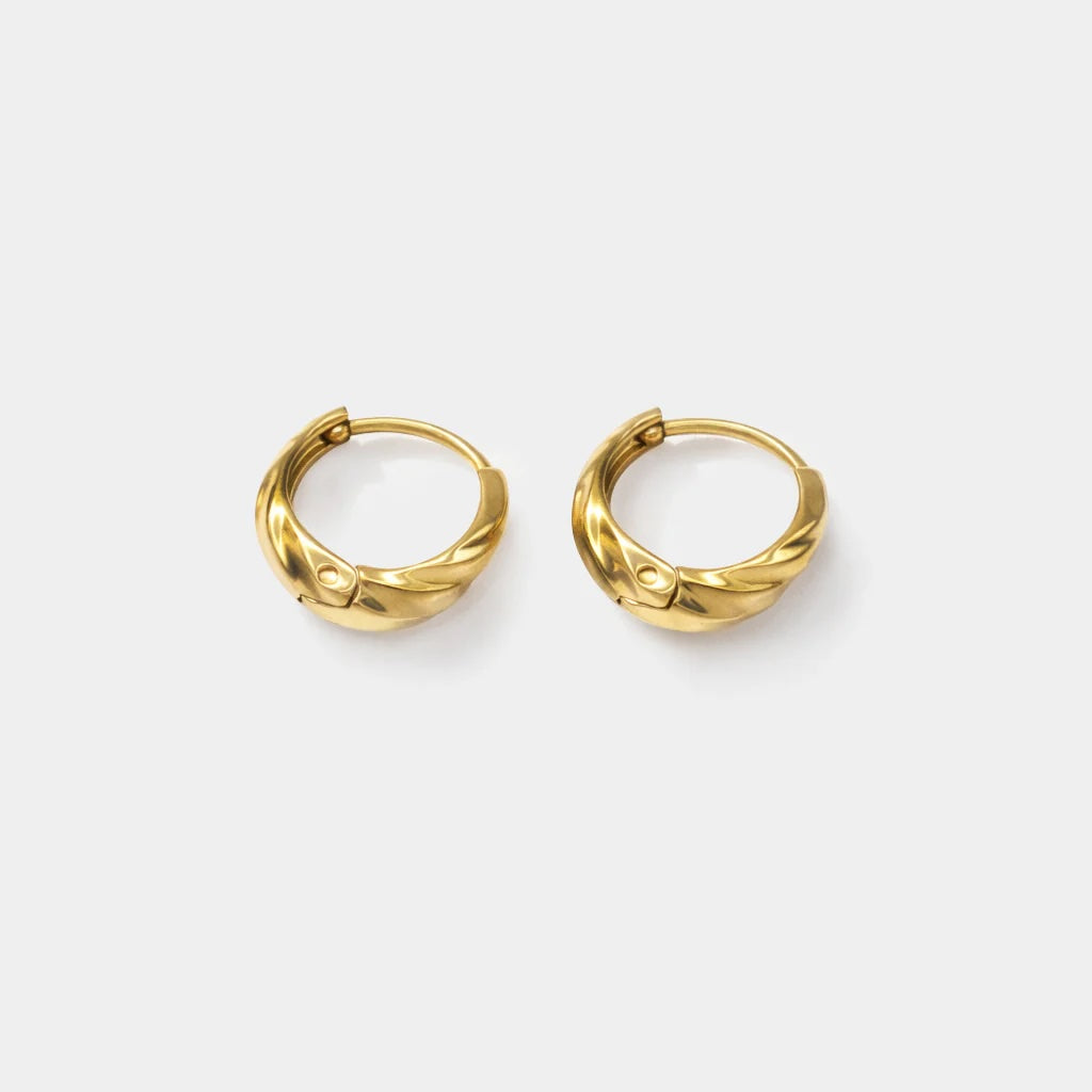Twisted textured gold-tone hoop earrings catch the light with subtle elegance.