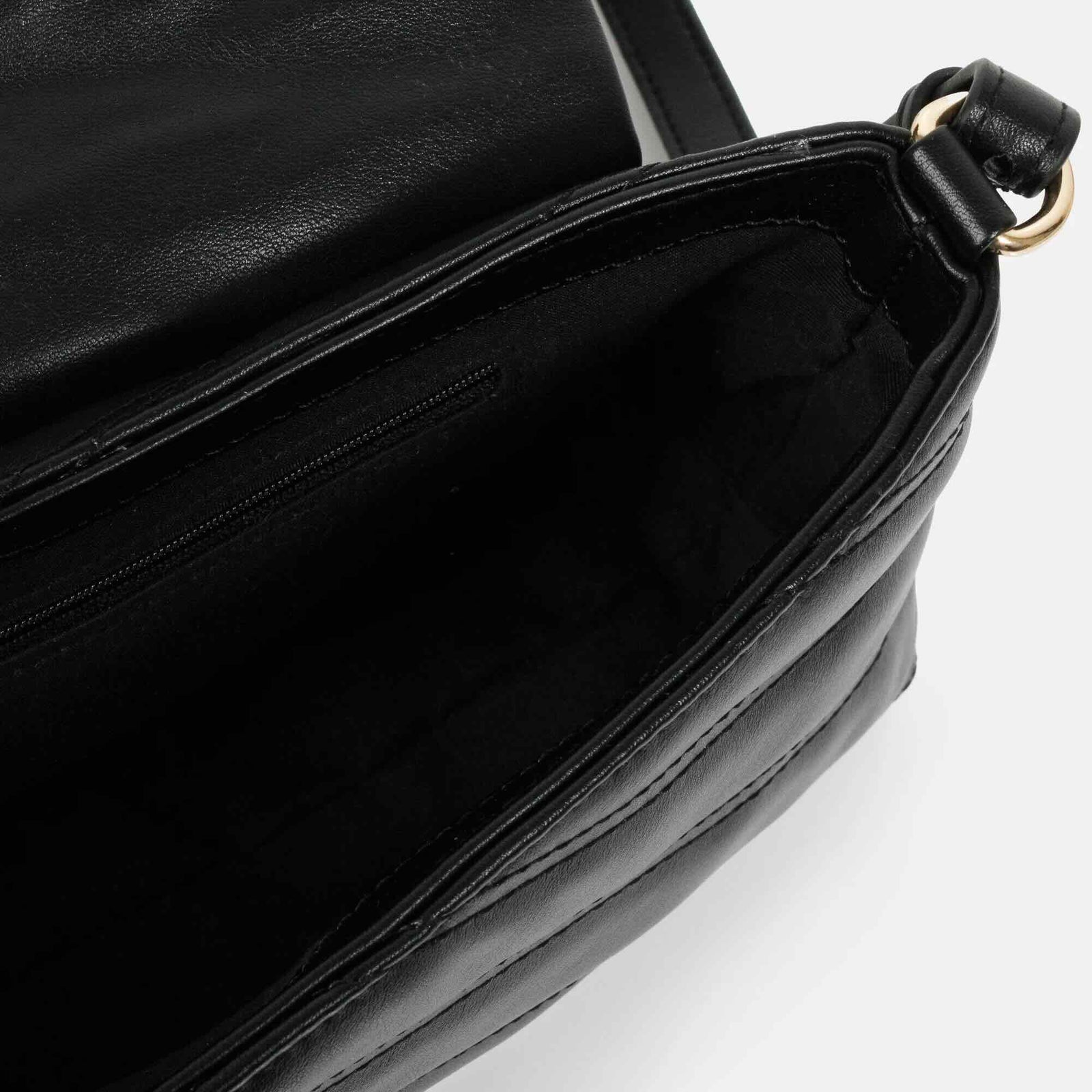 Black quilted PU crossbody bag with V-stitch detailing, interior zip pocket, and adjustable strap.