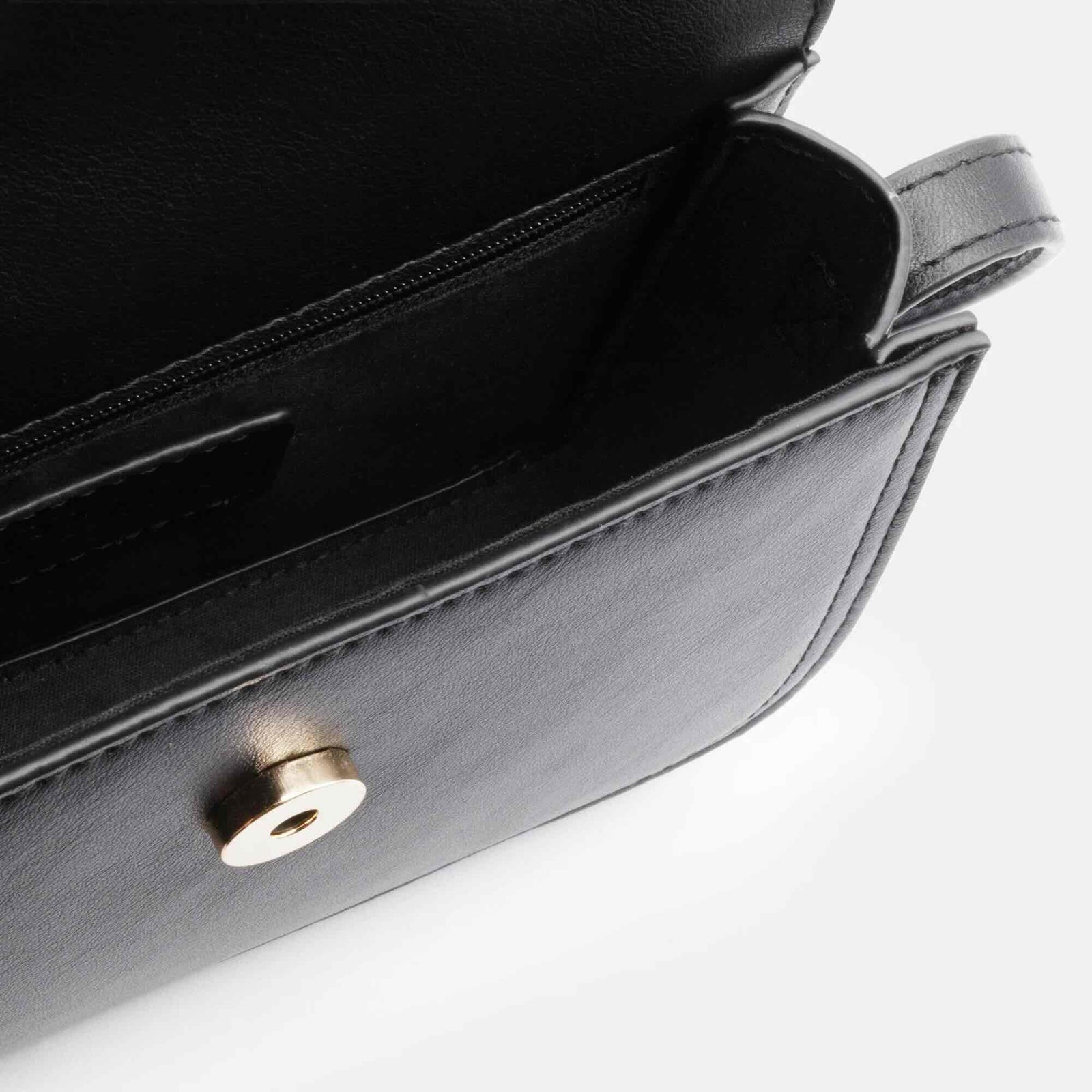 Black smooth PU shoulder bag with an asymmetric flap and gold hardware, a compact minimalist silhouette.