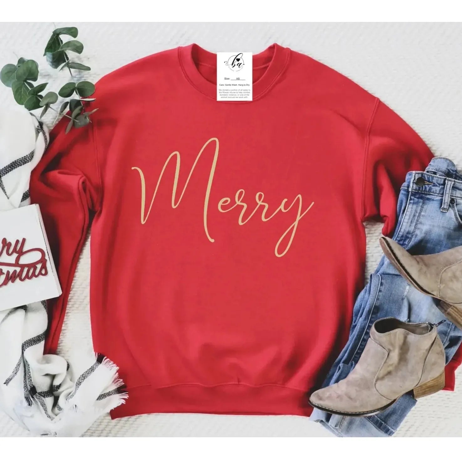 Merry Crew red sweatshirt with gold 'Merry' script; standard-fit, 50/50 poly-cotton, styled with jeans and boots.