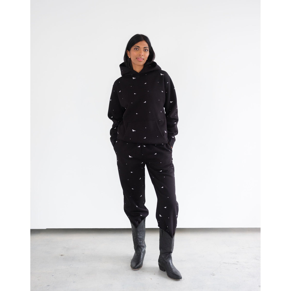 Model wearing Brunette the Label All Over Horse Hoodie with matching pants in black and white horse prints.
