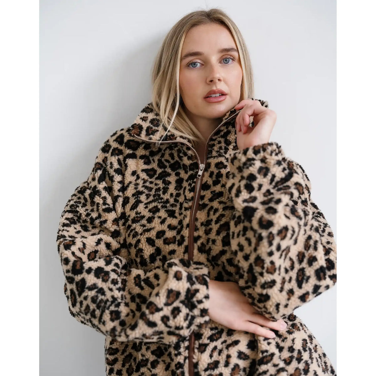 Oversized leopard print sherpa jacket with full front zipper, relaxed fit, and soft textured fleece fabric.