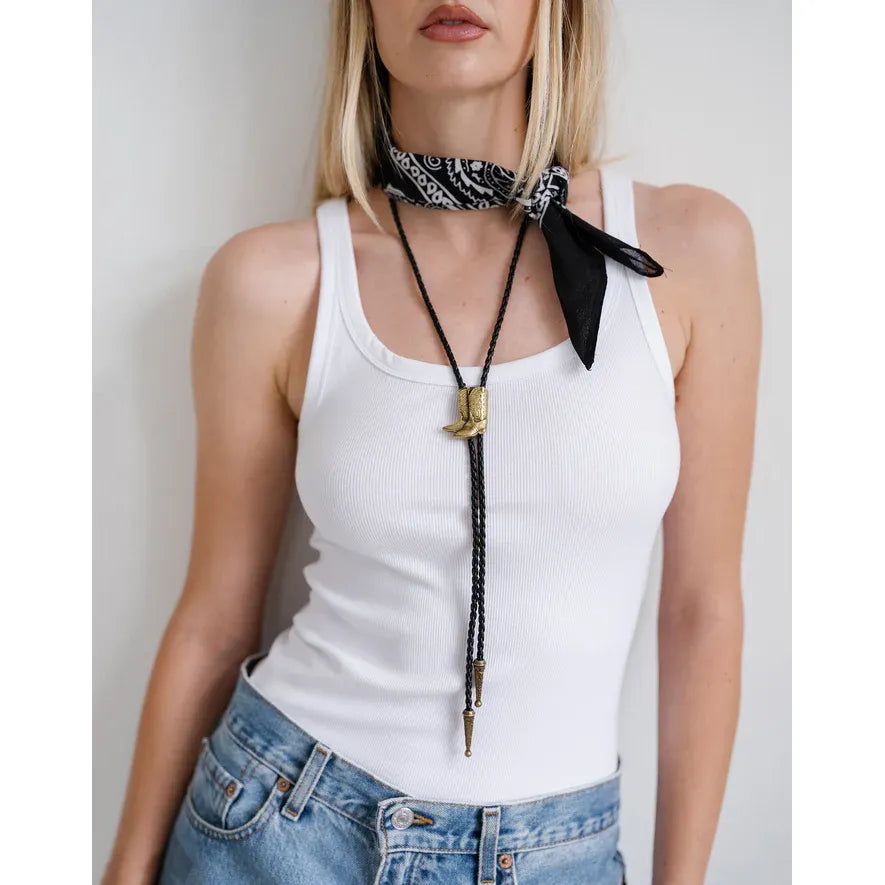Brunette the Label Bolo Tie: black faux leather cords with gold boot-inspired accent.