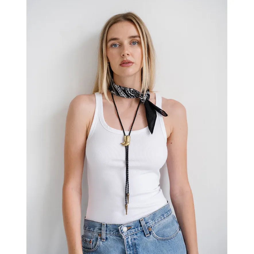 Brunette the Label Bolo Tie with black faux leather cord and gold boot charm.