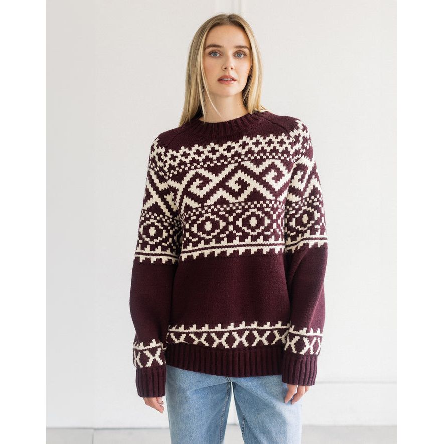 Plum oversized Fair Isle knit sweater featuring bold cream geometric patterns across the chest and hem.
