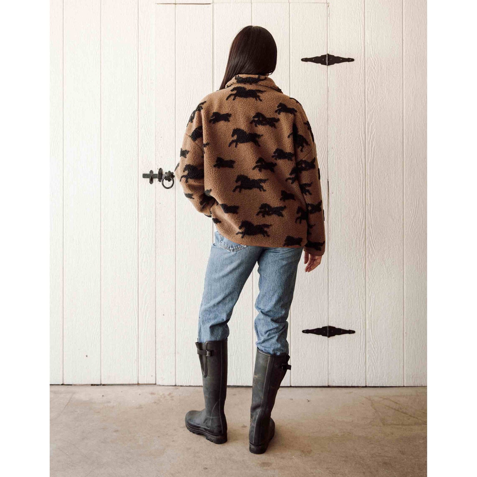 Brunette the Label full-zip horse-print sherpa jacket on model; tan with black horses, cozy collar, paired with jeans.
