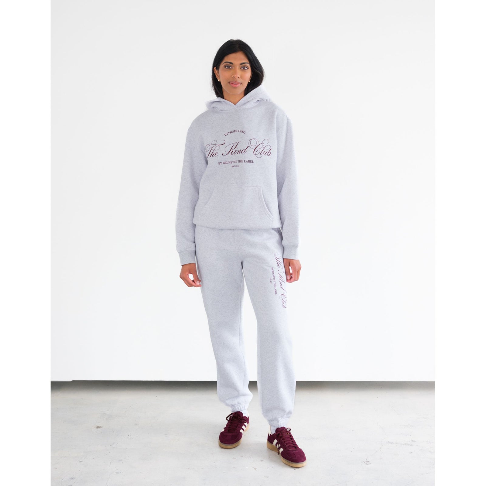 Brunette the Label Kind Club Core Hoodie in heather gray with burgundy script on the chest, paired with matching joggers.
