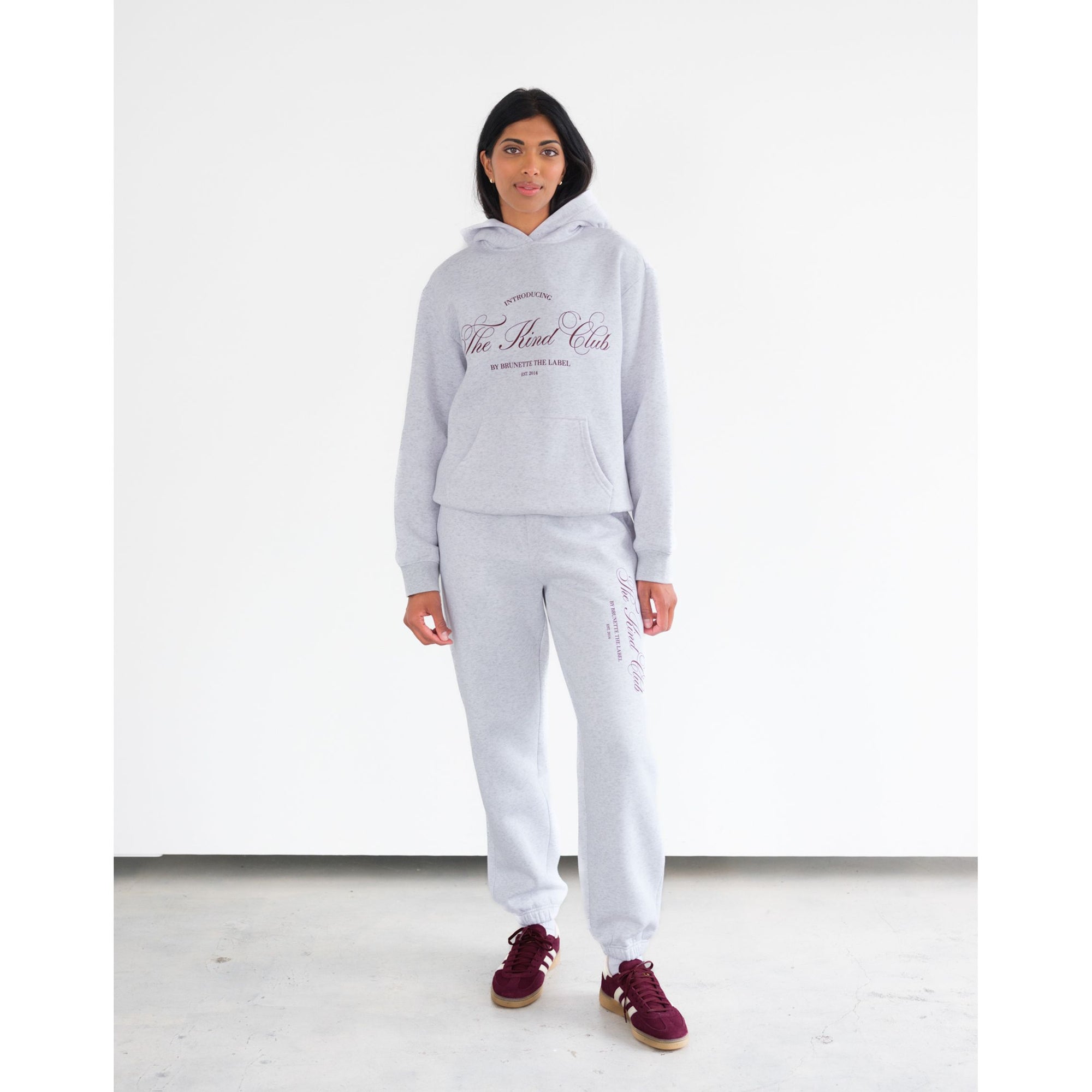 Brunette the Label Kind Club Core Hoodie in heather gray with burgundy script on the chest, paired with matching joggers.