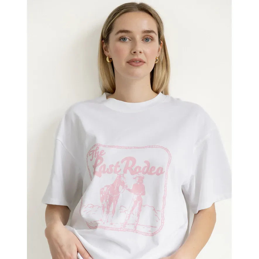 Brunette the Label Last Rodeo Boxy Tee on a model; white oversized cotton tee with a pink Last Rodeo graphic.