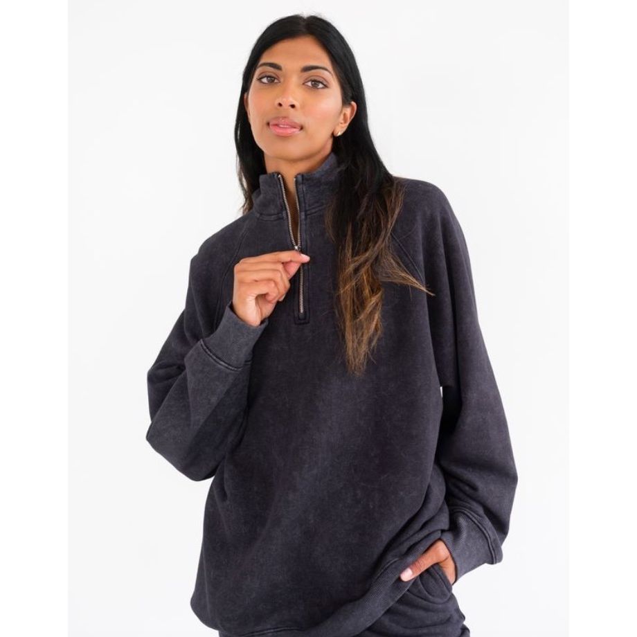 Brunette the Label Not Your Boyfriend&#39;s 1/2 Zip washed black pullover on a model.