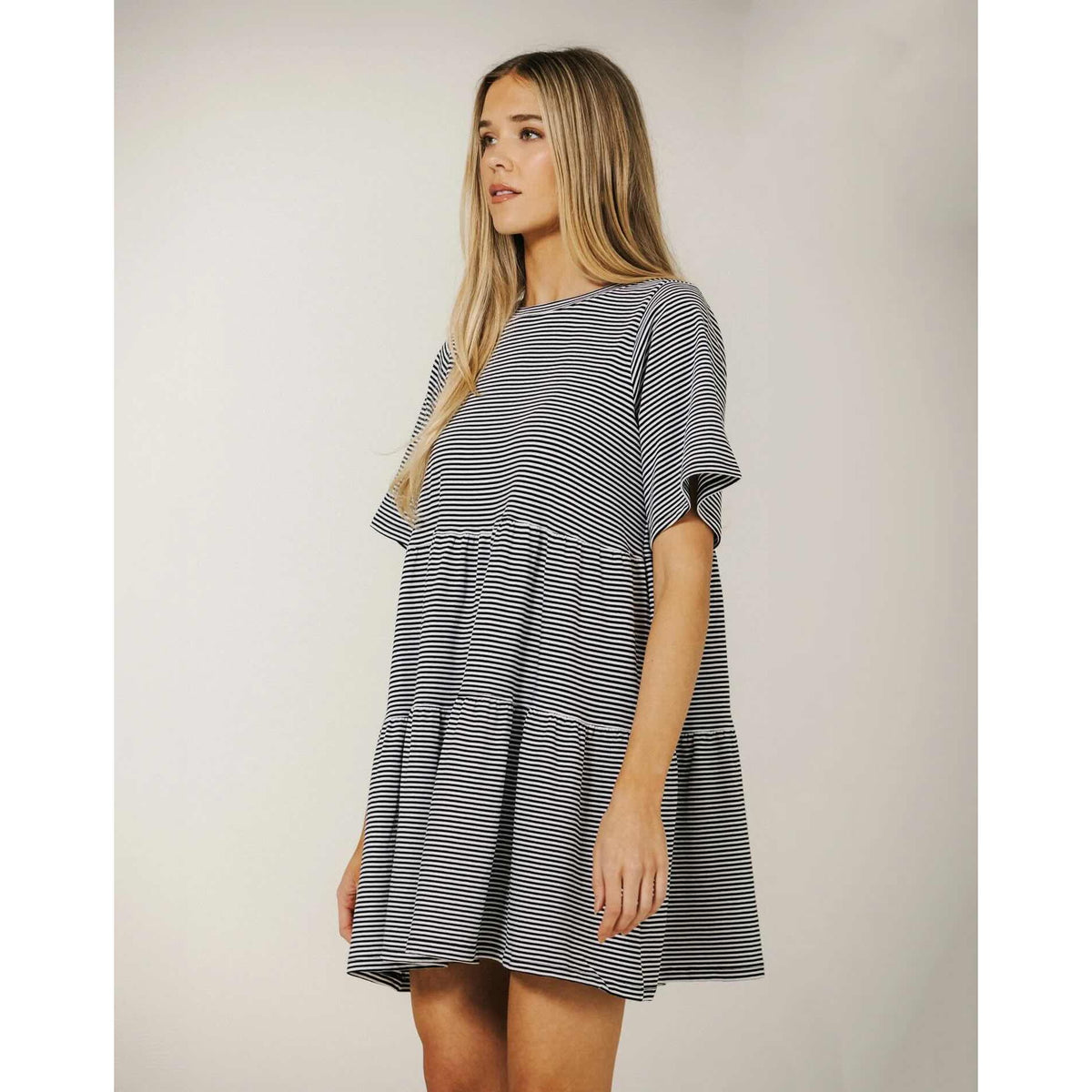 Brunette The Label Tiered Dress on model, navy and white stripes, oversized relaxed fit, tiered skirt.