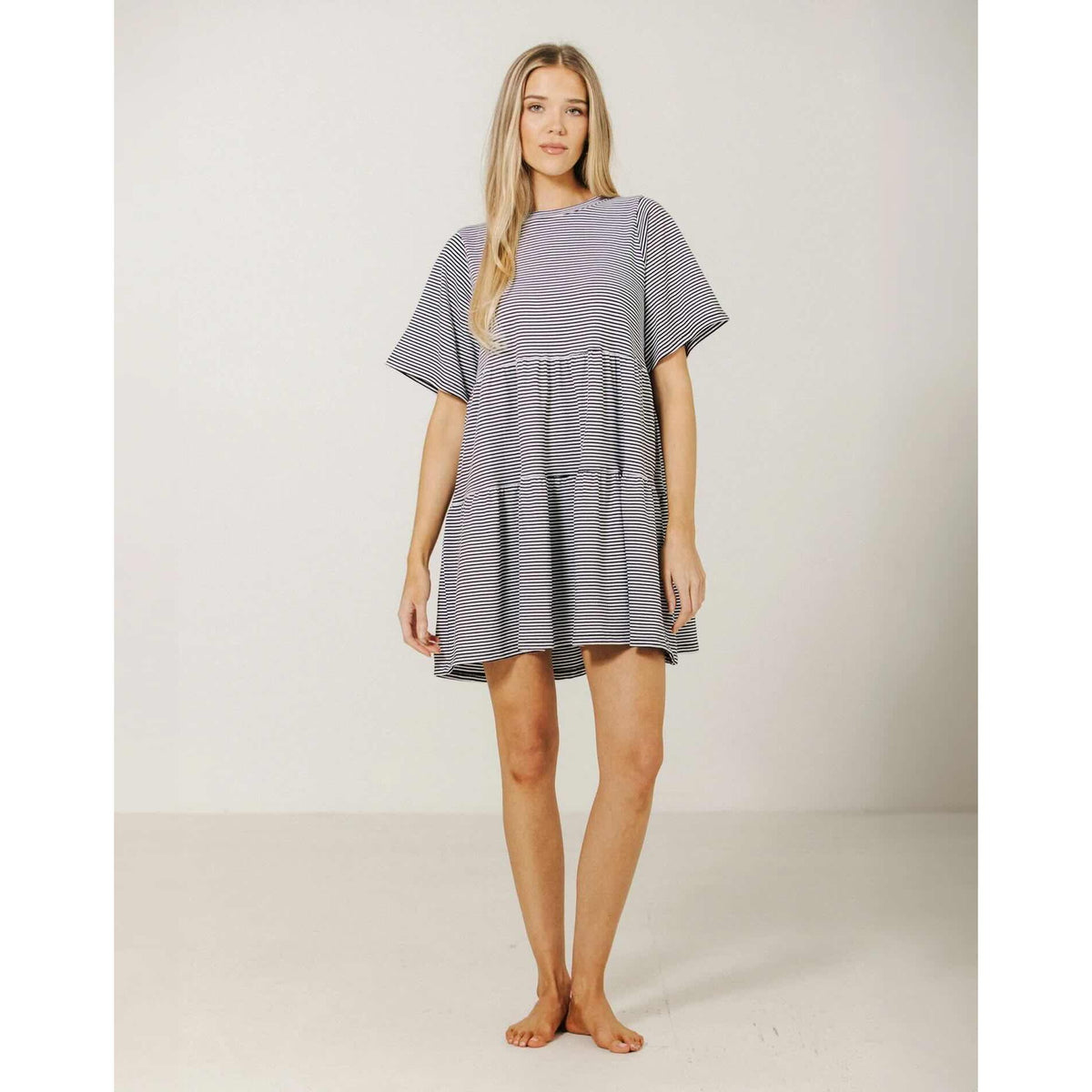 Brunette The Label Tiered Dress in navy-white stripes, oversized relaxed fit with tiered skirt and short sleeves.