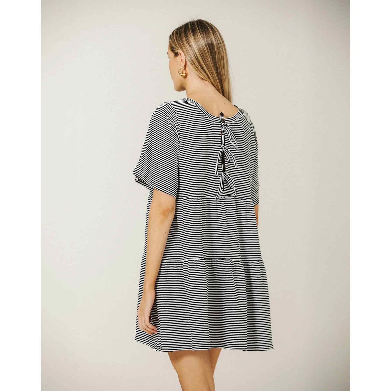 Brunette The Label Tiered Dress in black-and-white stripes, loose fit, three back bows, short sleeves, 100% cotton