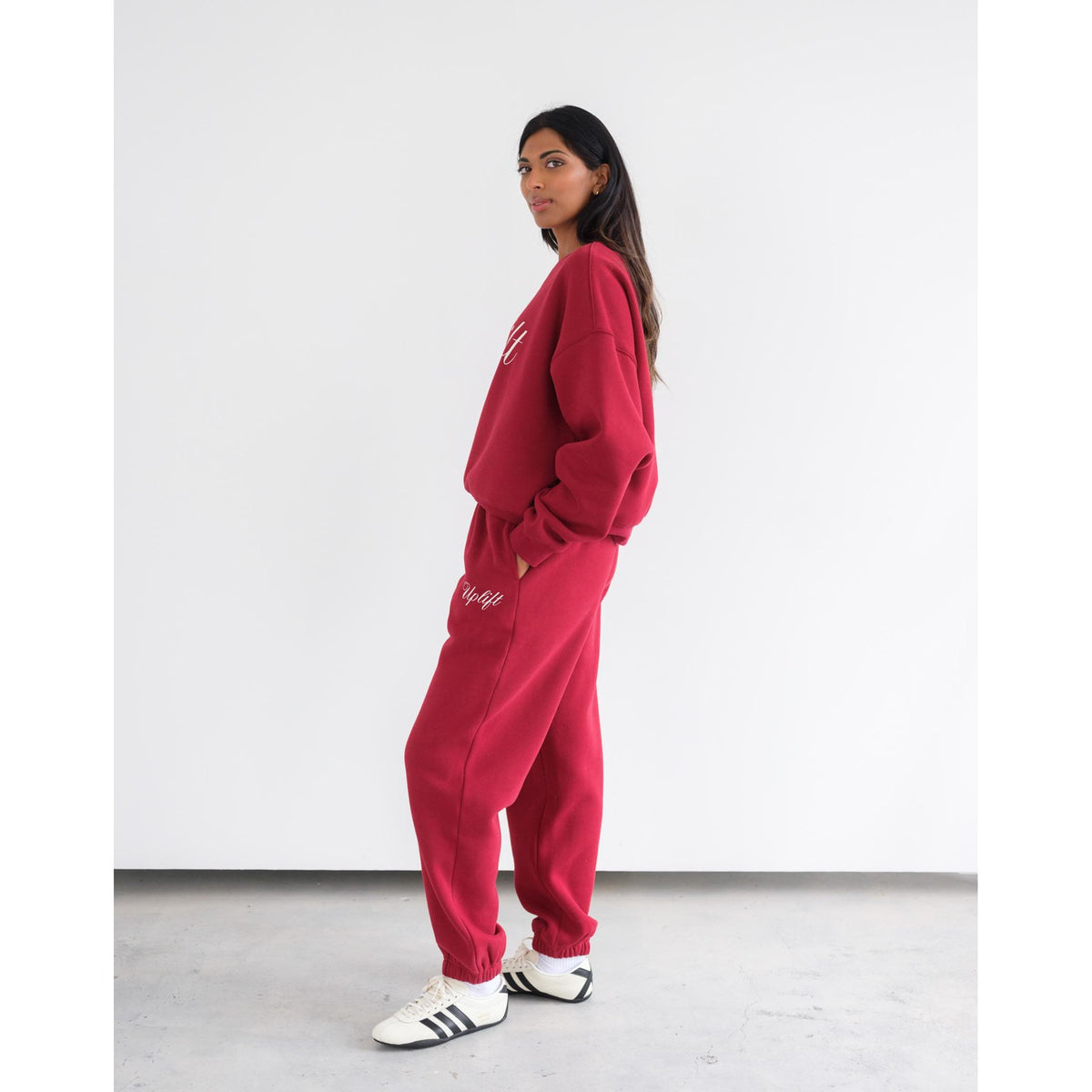 Brunette the Label Uplift Oversized Jogger in red fleece on a model with high-rise waist, wide legs, and two pockets.