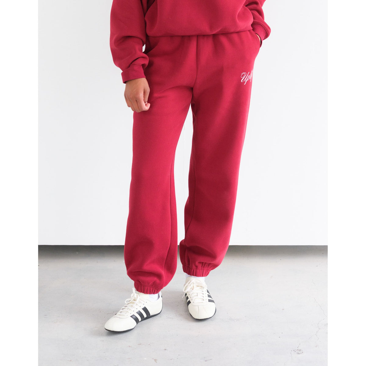 Brunette the Label Uplift Oversized Jogger in burgundy with high-rise drawstring waist and wide legs, side pockets.