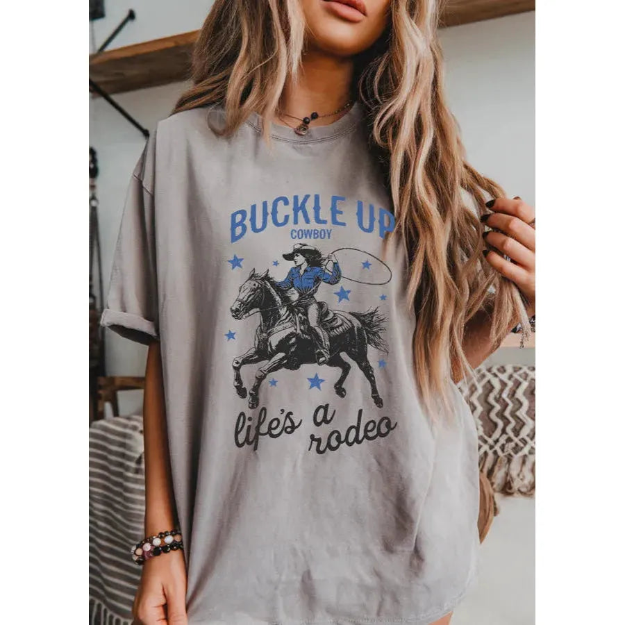 Buckle up Cowboy Tee showcases rodeo vibes with a playful design, perfect for casual, wild west-inspired outfits.