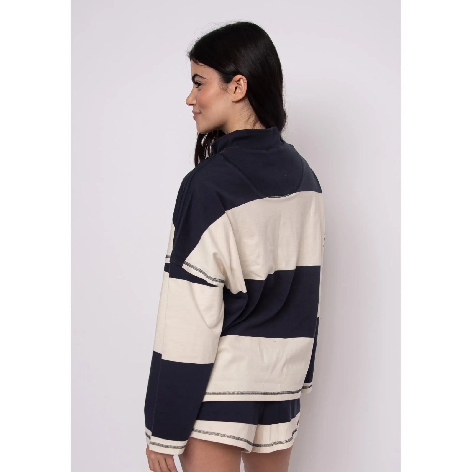 Camille Striped 1/2 Zip Rugby Shirt worn by model, navy and cream stripes, back view.