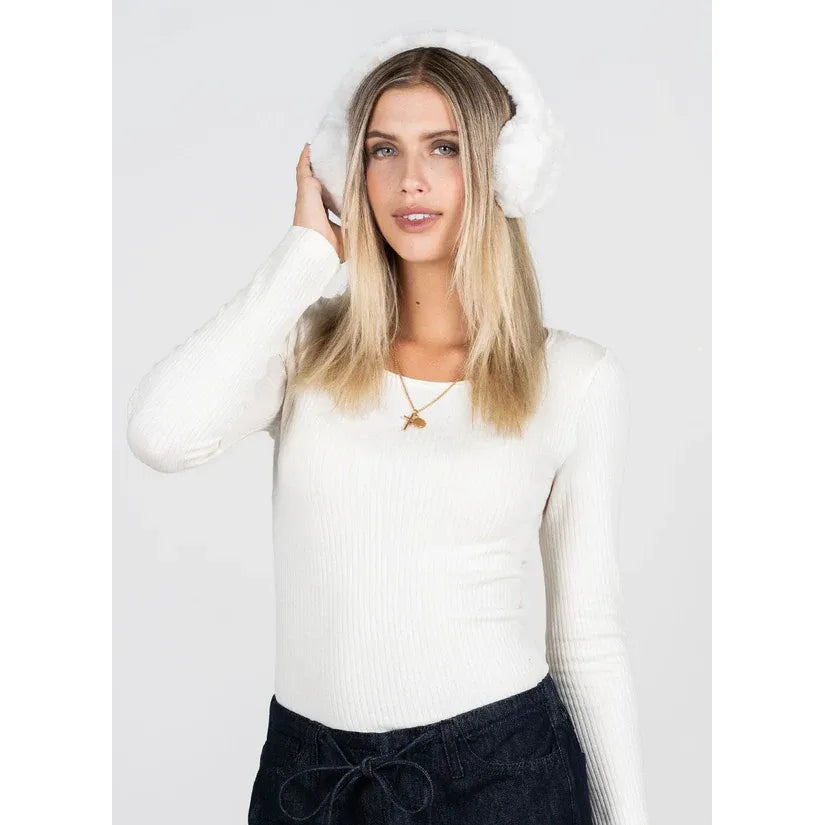 Model wearing C&#39;est Moi Faux Fur Ear Muffs in white, paired with a white knit sweater.