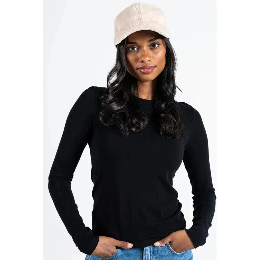 Beige C'est Moi plush baseball hat worn by a woman in a black top and jeans.