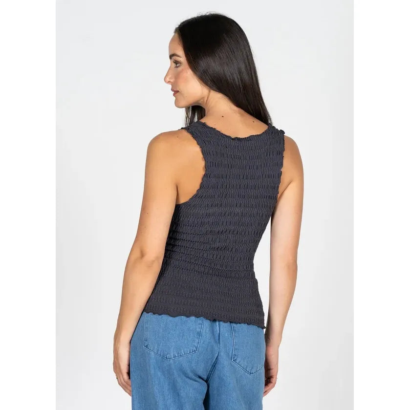 Back view of a dark grey textured smocked bamboo V-neck tank with a contoured silhouette, shown here paired with blue jeans.