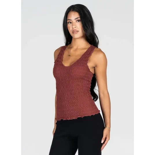 Textured rust smocked V-neck tank with contoured silhouette. Bamboo rayon blend hip-length top in one size.