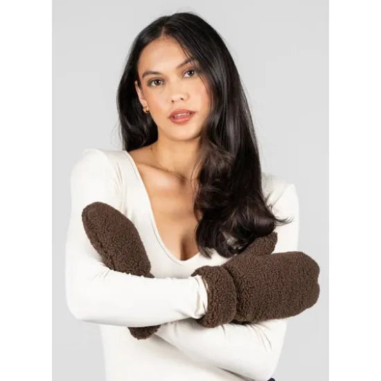 Brown shearling style mittens with plush interior. Soft, warm winter handwear made from 100% polyester for cozy protection in cold weather.