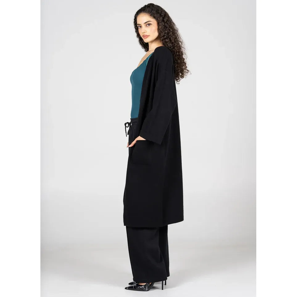 C'est Moi Viscose Blend Long Knit Cardigan on model, black, long silhouette with clasp closure, fold-over sleeves, pockets