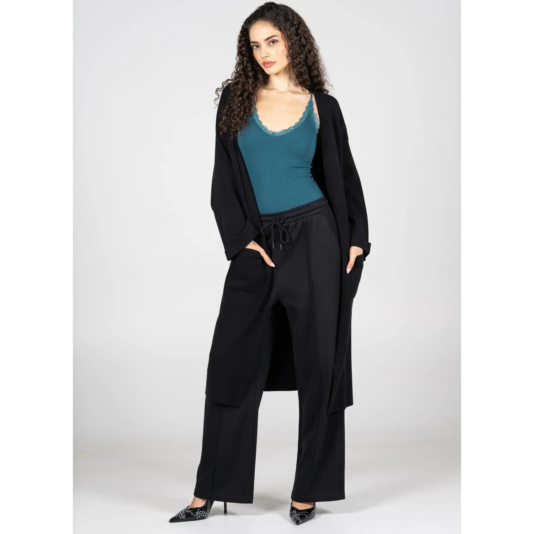 C'est Moi Viscose Blend Long Knit Cardigan, black long silhouette with clasp front and fold-over sleeves over teal top.