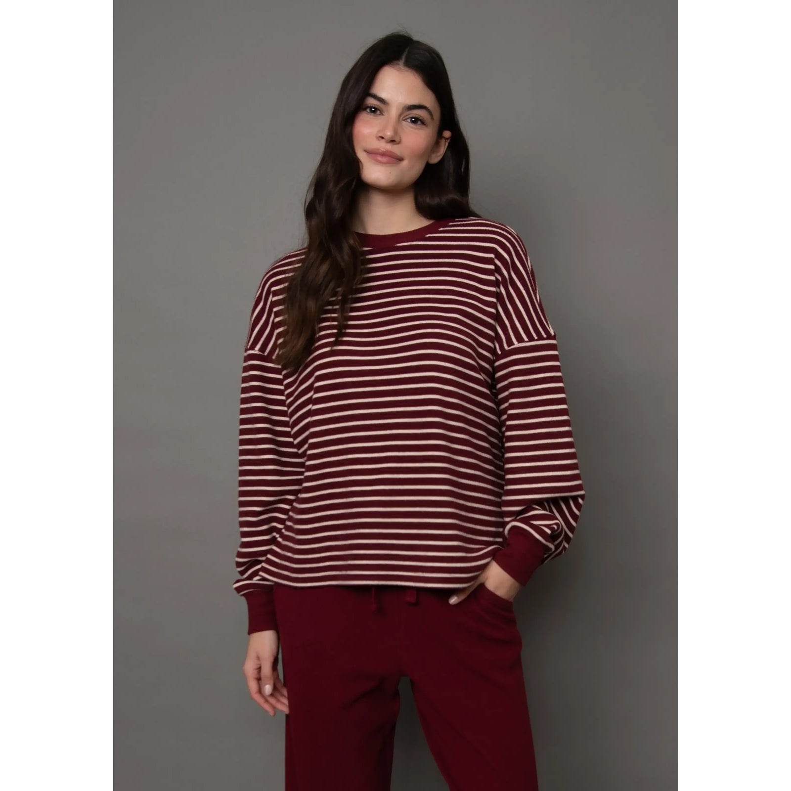 Burgundy and cream striped waffle knit long-sleeve top with a relaxed fit and horizontal striping.