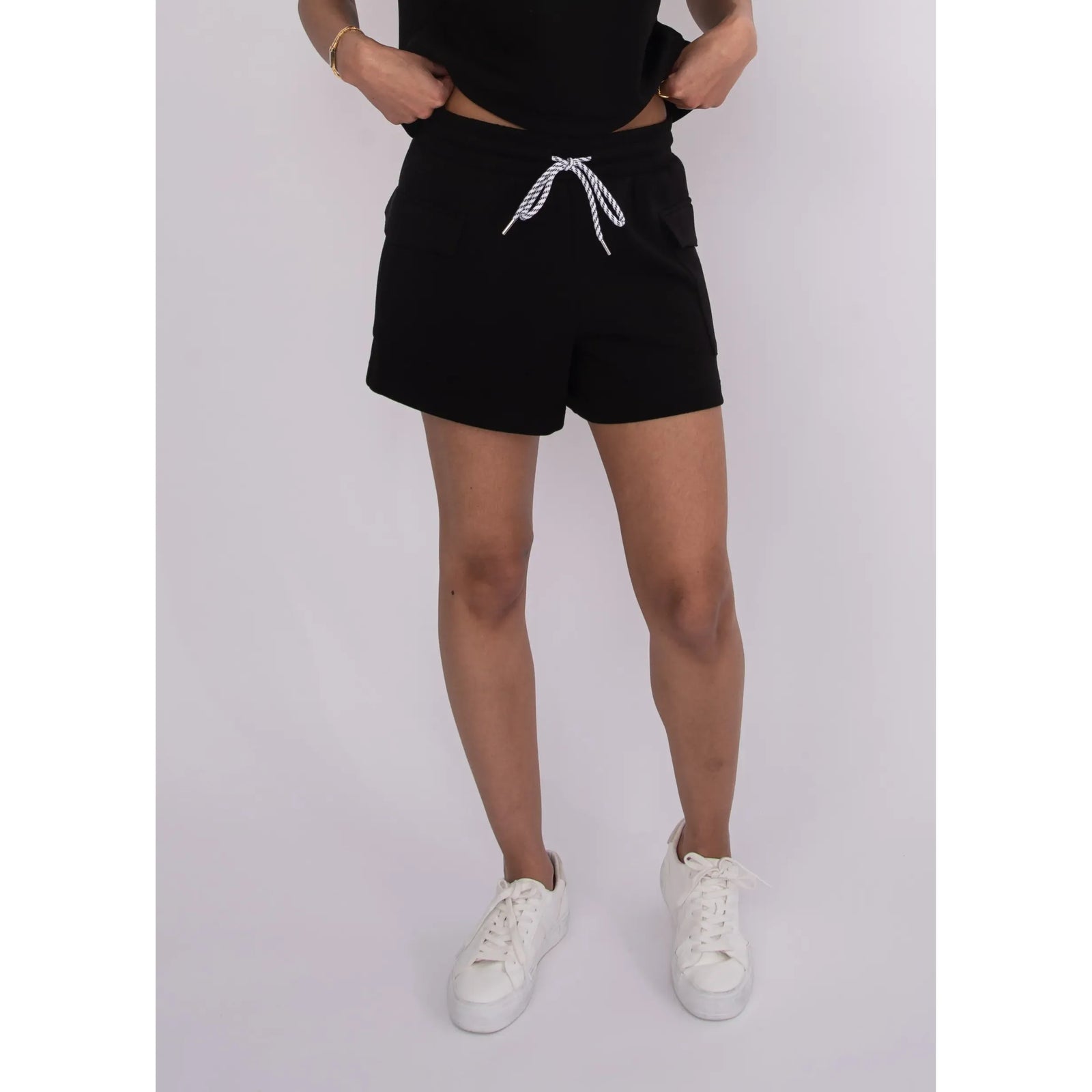 Darcia Soft Knit Drawstring Shorts in black with front pockets and a white drawstring.