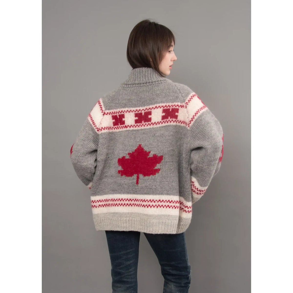 Back view of a grey Daria raglan shawl collar sweater featuring a red maple leaf motif and cream patterned bands.