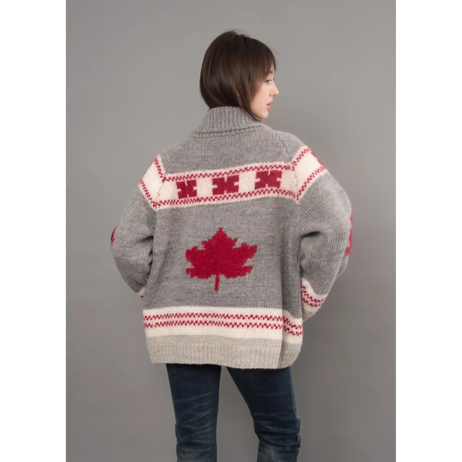 Back view of a grey Daria raglan shawl collar sweater featuring a red maple leaf motif and cream patterned bands.