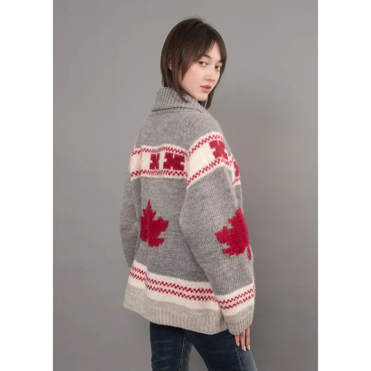Grey Daria raglan shawl collar sweater featuring red maple leaf motifs, patterned bands, and cozy knit texture.