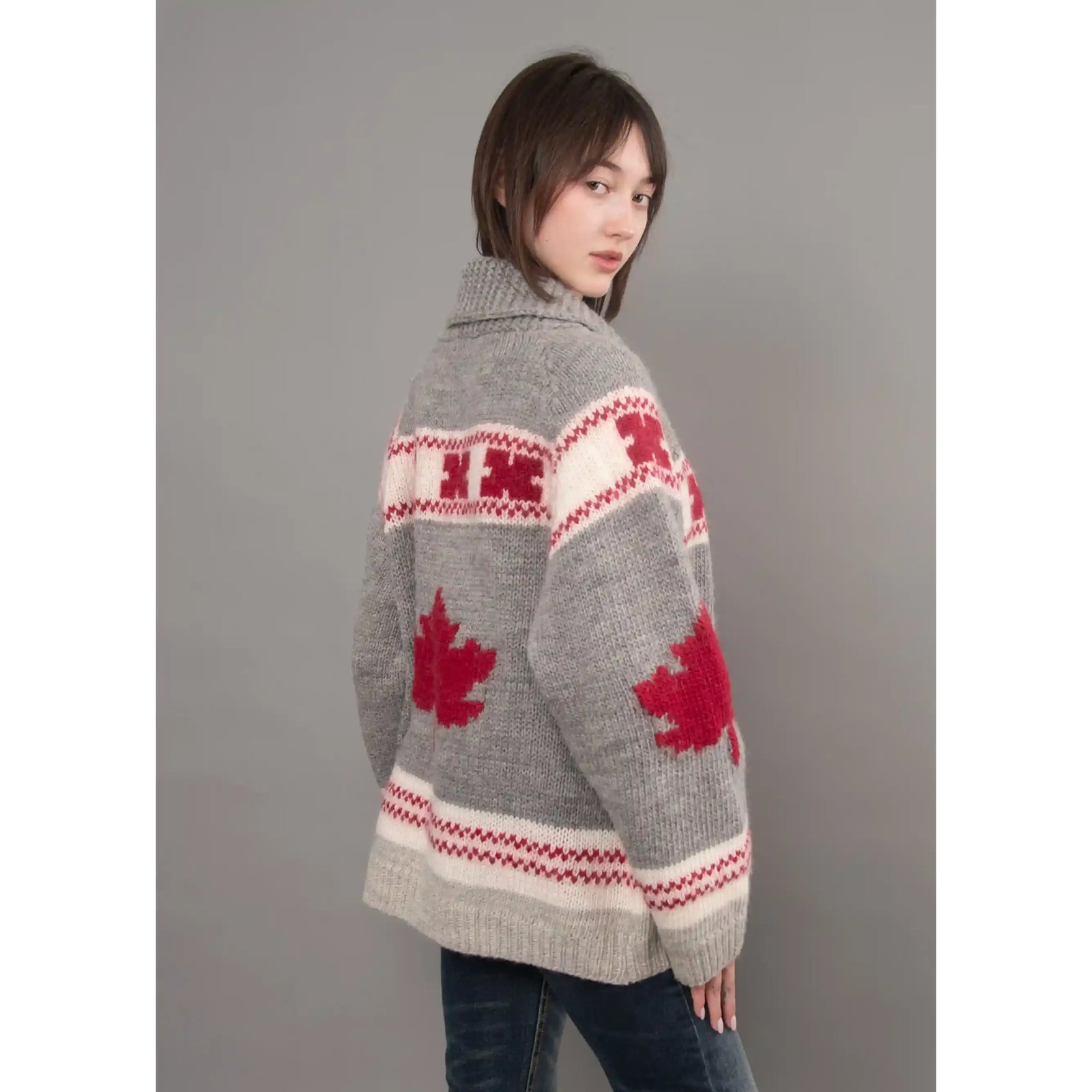 Grey Daria raglan shawl collar sweater featuring red maple leaf motifs, patterned bands, and cozy knit texture.